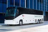 Motor Coach parked beside a building